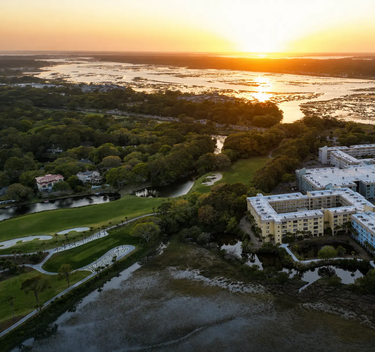 Fairway, marsh and resort at sunset, shot by drone